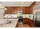 Well-lit kitchen boasts stainless steel appliances and granite countertops, paired with sleek, dark wood cabinetry at 18067 E Anthem Dr, Parker, CO 80134