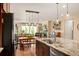Open concept kitchen features an island with granite countertops and sink, seamlessly transitioning into the dining and living areas at 18067 E Anthem Dr, Parker, CO 80134