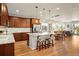 Open concept kitchen with granite countertops, center island, and hardwood floors at 18067 E Anthem Dr, Parker, CO 80134