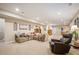 Open living area with a sectional sofa, recliner chair, side tables, and adjacent dining area at 18067 E Anthem Dr, Parker, CO 80134