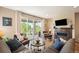 Spacious living room with modern fireplace, plush seating and sliding glass doors to patio at 18067 E Anthem Dr, Parker, CO 80134