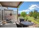 Cozy outdoor patio with lounge chair and table with sun decoration and landscaping offers a relaxing retreat at 18067 E Anthem Dr, Parker, CO 80134