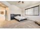 Bedroom with neutral paint, carpet, a king sized bed, a dresser, and good natural light at 16534 E Fire Fly Ave, Parker, CO 80134
