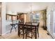 Comfortable dining room with natural lighting and an elegant chandelier above the dark wood table at 16534 E Fire Fly Ave, Parker, CO 80134