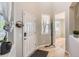 Bright entryway with wood-look floors, white door, adjacent to the open layout of the home at 16534 E Fire Fly Ave, Parker, CO 80134