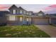 Charming home featuring a brick facade, covered porch, and well-manicured front yard at 16534 E Fire Fly Ave, Parker, CO 80134
