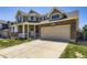 Spacious two car garage with brick and siding exterior, and a large driveway at 16534 E Fire Fly Ave, Parker, CO 80134