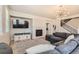 Comfortable living room featuring a fireplace, a large sectional sofa, and a mounted flatscreen TV at 16534 E Fire Fly Ave, Parker, CO 80134