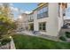 Exterior shot of the backyard, showing the patio, lawn, and the home's facade at 15218 W La Salle Ave, Lakewood, CO 80228