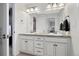 Bright bathroom featuring double vanity, granite counters, and decorative lighting at 15218 W La Salle Ave, Lakewood, CO 80228
