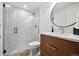Modern bathroom features a walk-in shower with glass enclosure and stylish vanity at 15218 W La Salle Ave, Lakewood, CO 80228