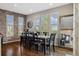 This elegant dining room features hardwood floors, a brick accent wall, and lots of natural light at 15218 W La Salle Ave, Lakewood, CO 80228
