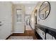 Inviting hallway with hardwood floors, decorative rug, designer mirror, and transom window at 15218 W La Salle Ave, Lakewood, CO 80228