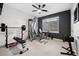 Fully equipped home gym with weight machines and black accent wall at 15218 W La Salle Ave, Lakewood, CO 80228