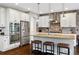 Beautiful kitchen featuring stainless steel appliances, a brick backsplash, and a kitchen island at 15218 W La Salle Ave, Lakewood, CO 80228