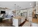Open-concept kitchen with stainless steel appliances and a large island at 15218 W La Salle Ave, Lakewood, CO 80228