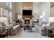 Bright and airy living room with a cozy fireplace, comfortable seating, and stylish decor at 15218 W La Salle Ave, Lakewood, CO 80228