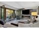 Cozy living room featuring a fireplace, large sectional sofa and sliding doors to the outside at 15218 W La Salle Ave, Lakewood, CO 80228