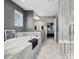 Luxurious main bathroom with marble flooring, soaking tub, and a glass-enclosed shower at 15218 W La Salle Ave, Lakewood, CO 80228