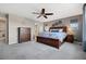 A well-lit main bedroom features a large bed, soft carpeting, and ample natural light at 15218 W La Salle Ave, Lakewood, CO 80228