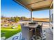 Covered patio with outdoor dining set and view of backyard at 4616 Girardot Pt, Castle Rock, CO 80104