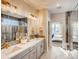 Spa-like bathroom with double vanity, large shower, and marble-like tile at 4616 Girardot Pt, Castle Rock, CO 80104