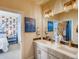 Bathroom with double vanity, white countertop, and a rabbit-themed adjacent bedroom at 4616 Girardot Pt, Castle Rock, CO 80104