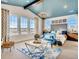 Main bedroom with vaulted ceiling, large windows, and a luxurious sitting area at 4616 Girardot Pt, Castle Rock, CO 80104