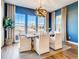 Elegant dining room with blue walls, a large table, and modern chandelier at 4616 Girardot Pt, Castle Rock, CO 80104