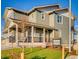 Two-story house with gray siding, a front porch, and a landscaped lawn at 4616 Girardot Pt, Castle Rock, CO 80104