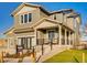 Two-story house with gray siding, a front porch, and a landscaped lawn at 4616 Girardot Pt, Castle Rock, CO 80104