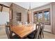 Open dining room featuring modern chandelier lighting, and a large wooden table for entertaining guests at 9142 Warriors Mark Dr, Franktown, CO 80116