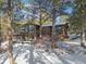 Beautiful mountain home surrounded by mature trees and a snowy landscape at 9142 Warriors Mark Dr, Franktown, CO 80116