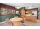 Open floor plan: Kitchen dining area featuring wooden cabinets, a decorative bookcase, and sliding glass doors to an outdoor balcony at 9142 Warriors Mark Dr, Franktown, CO 80116