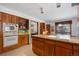 Spacious kitchen featuring wooden cabinetry, granite countertops, and modern appliances at 9142 Warriors Mark Dr, Franktown, CO 80116