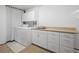 Functional laundry room equipped with white washer, dryer, and storage cabinets for organization at 9142 Warriors Mark Dr, Franktown, CO 80116