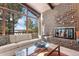 A brick fireplace is the focus of the living room, which also has amazing views from a large picture window at 9142 Warriors Mark Dr, Franktown, CO 80116