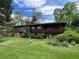 Large two-story home with a spacious backyard, mature trees, and a second-story balcony at 12075 W 18Th Dr, Lakewood, CO 80215