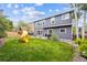 Landscaped backyard featuring a playset, patio with grill, and spacious lawn creating a perfect outdoor living space at 13560 Detroit St, Thornton, CO 80241