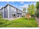 Well-maintained backyard with lush lawn, patio seating, and playset, ideal for outdoor entertainment and Gathering fun at 13560 Detroit St, Thornton, CO 80241