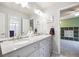 Elegant bathroom featuring a double sink vanity with granite countertops and modern fixtures creating a luxurious feel at 13560 Detroit St, Thornton, CO 80241