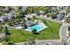 Aerial view of the community pool area with well-maintained landscaping and nearby homes at 13560 Detroit St, Thornton, CO 80241