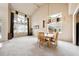 Bright dining room featuring a vaulted ceiling, large windows, and a modern chandelier at 13560 Detroit St, Thornton, CO 80241