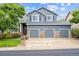 Charming two-story home with a three-car garage and a well-maintained lawn at 13560 Detroit St, Thornton, CO 80241