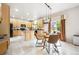 Bright eat-in kitchen with wooden cabinetry, a center island, and a sliding glass door at 13560 Detroit St, Thornton, CO 80241