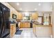 Bright kitchen featuring light wood cabinets, modern appliances, and tile flooring at 13560 Detroit St, Thornton, CO 80241