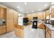 Spacious kitchen featuring lots of cabinetry and an island with tile countertop at 13560 Detroit St, Thornton, CO 80241