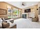Bright living room boasts large windows, a cozy fireplace with built-ins, and plush carpeting at 13560 Detroit St, Thornton, CO 80241
