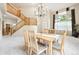Bright living room featuring a staircase, large windows, and neutral carpeting at 13560 Detroit St, Thornton, CO 80241
