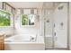 Main bathroom boasting a soaking tub and separate glass enclosed shower at 13560 Detroit St, Thornton, CO 80241